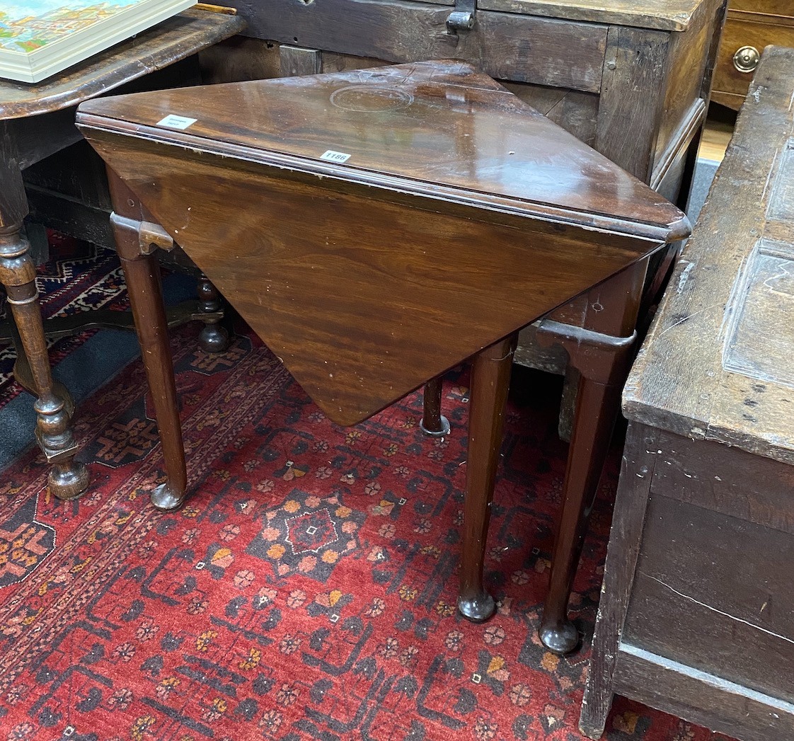 A 19th century triangular folding mahogany pad foot occasional table, width 79cm, depth 43cm, height 71cm